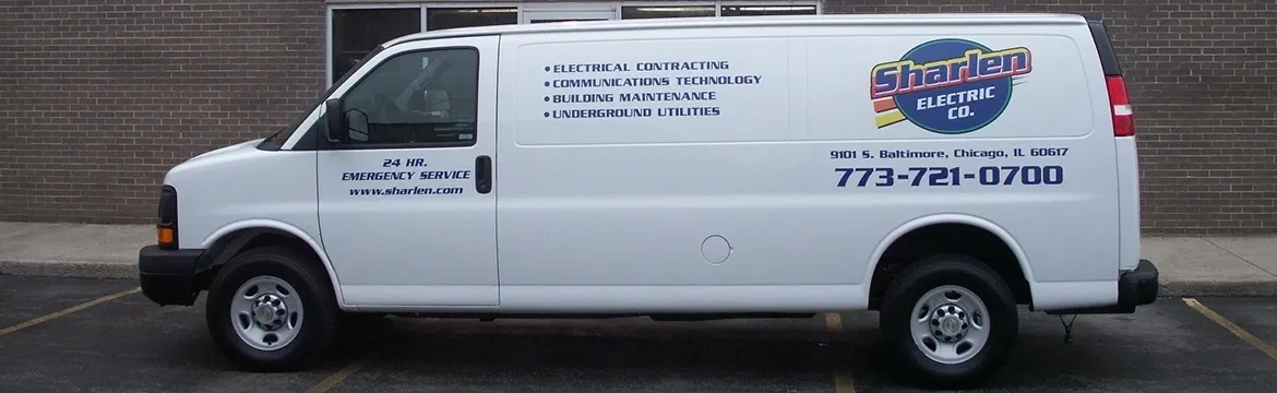 A white van with the words " electrical contracting, communications technology ," building maintenance and underground utilities on it.