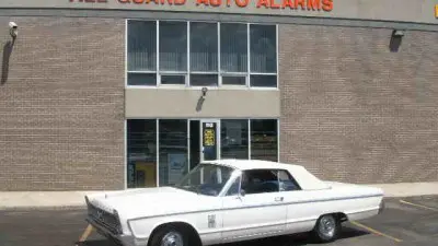 A white car parked in front of a building.